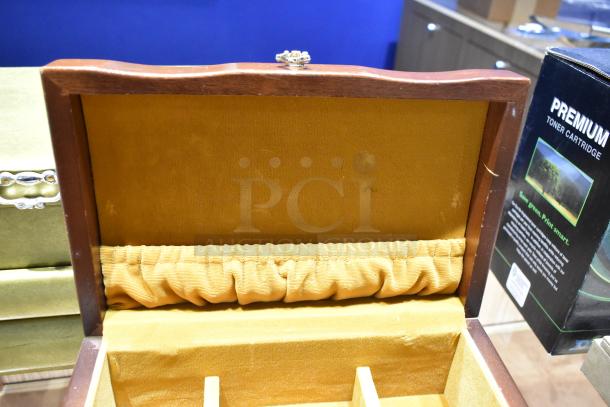 Two jewelry cases with contents including a watch, pin, and necklaces. Interior shows a plush, elastic-lined section.