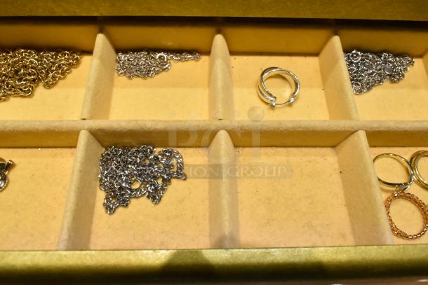Two jewelry cases with various contents including a watch, pin, and necklaces. Cases feature multiple compartments. Good condition.