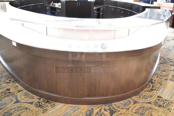 Curved wooden jewelry case, lighted, 4 rear doors, glass display, dark finish. Removal requires tools and manpower.