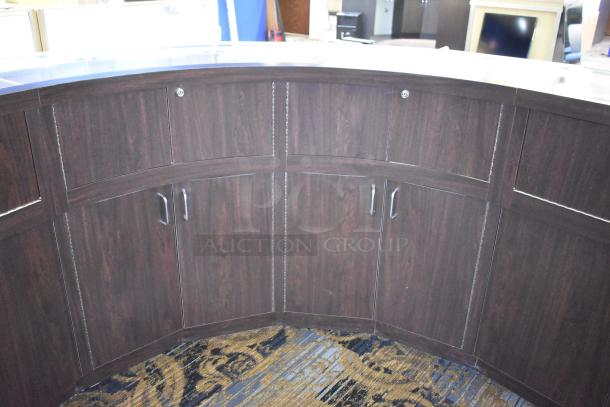 Curved wooden jewelry case with four rear doors. Features a lighted display area. Excellent condition. Buyer must remove.