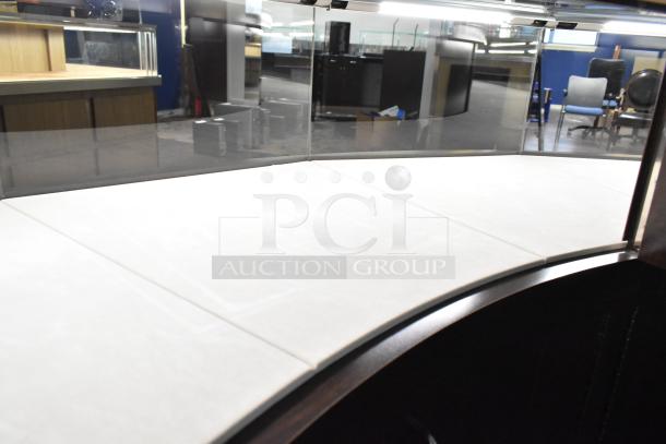 Wooden curved lighted jewelry case with four rear doors, excellent condition, sleek glass top, buyer responsible for removal.