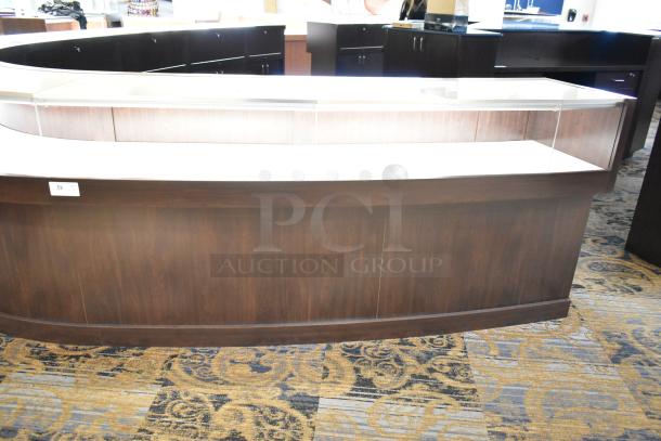 Wooden lighted jewelry case with four rear doors and three drawers, in good condition. Buyer must bring tools for removal.