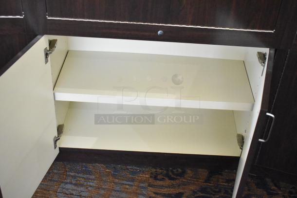 Wooden lighted jewelry case with four rear doors and three drawers, in good condition. Buyer must remove.