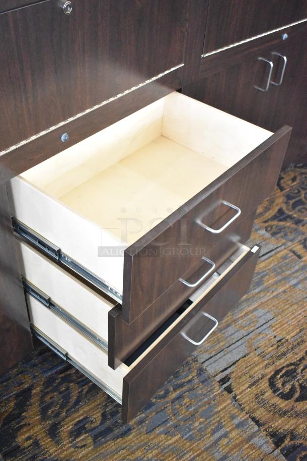 Wooden lighted jewelry case with 4 rear doors, 3 drawers, and metal handles. Buyer must remove; bring tools.