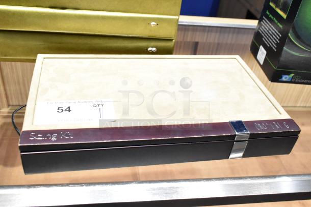 Ring sizing kit in Art Carved case, sizes 3.5 to 16 with half sizes. Metal clasp. Label reads "Sizing Kit".