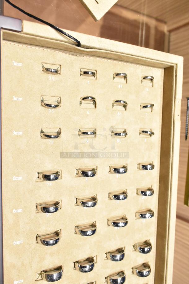 Ring sizing kit in Art Carved case, sizes 3.5 to 16, includes half sizes. Displayed in a cream fabric-lined case.