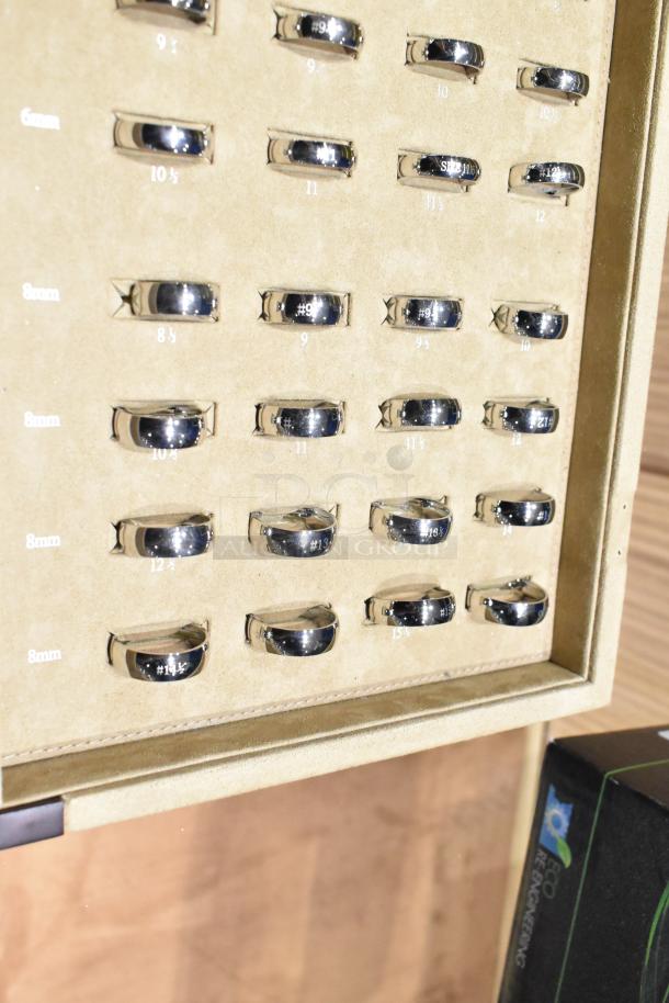 Ring sizing kit in Art Carved case, sizes 3.5 to 16 with half sizes, featuring multiple shiny metal rings in a display.