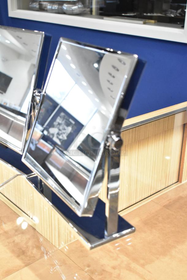 Three countertop mirrors with chrome frames and adjustable stands, excellent condition, reflecting a blue and wood background.