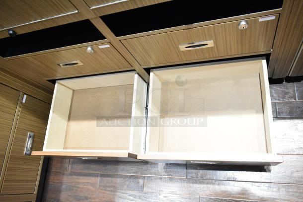 Wooden lighted jewelry case with four rear drawers, no key; buyer must bring tools for removal.