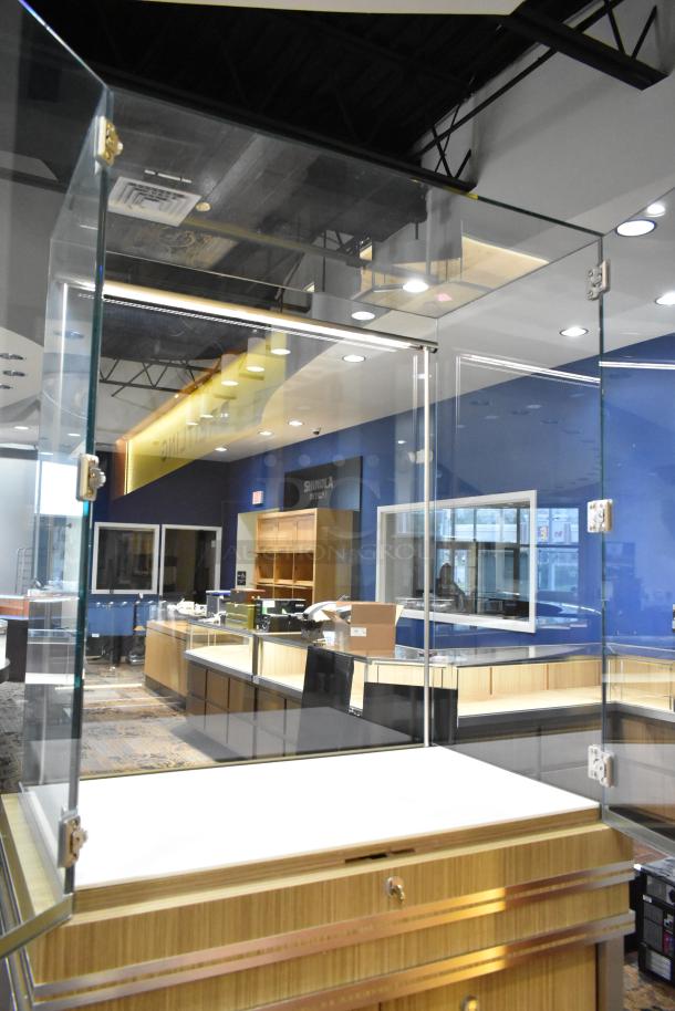 Wooden jewelry case with glass display, two rear doors, and secure hinges; requires tools for removal.