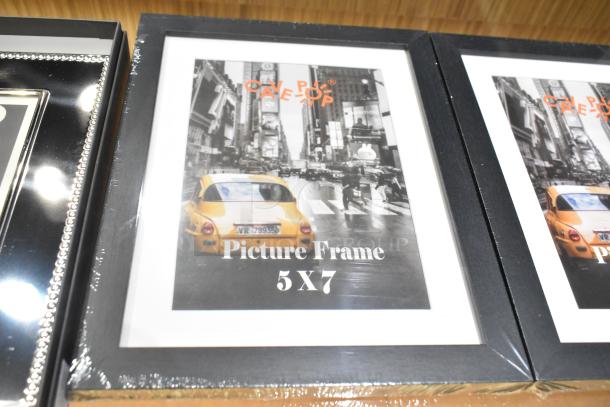 14 various items including 5x7 picture frames. Black frames with cityscape print. Mint condition, unopened packaging.