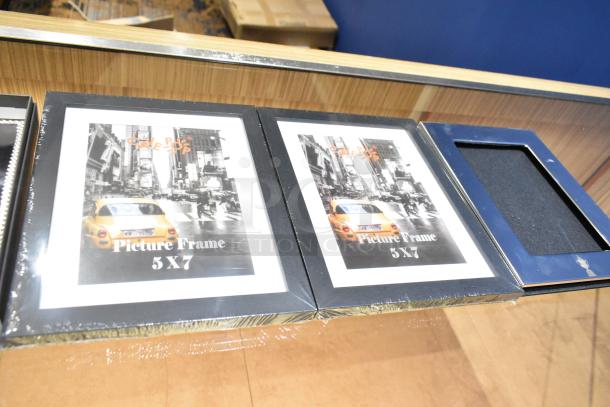 14 items including 5x7 picture frames; brand "Café OP". Ideal for decor, new condition, shrink-wrapped.