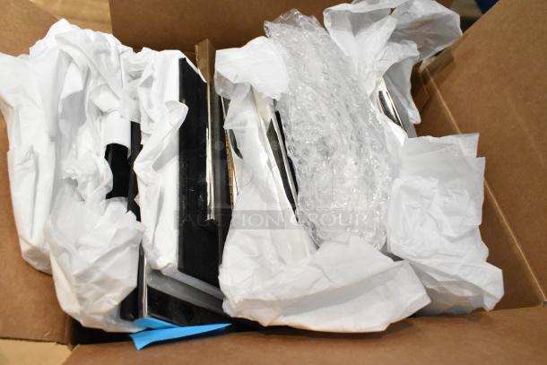 Box containing 14 assorted items including frames, wrapped in tissue and bubble wrap, indicating protective packaging.
