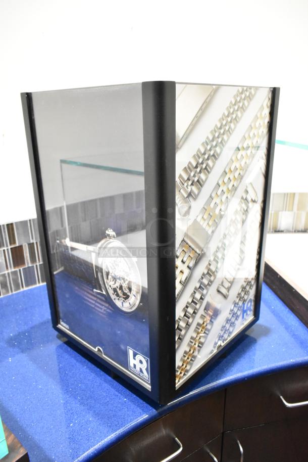 Hadley Roma display case with drawers, featuring glass panels and metal accents. Notable for branded "HR" logo.