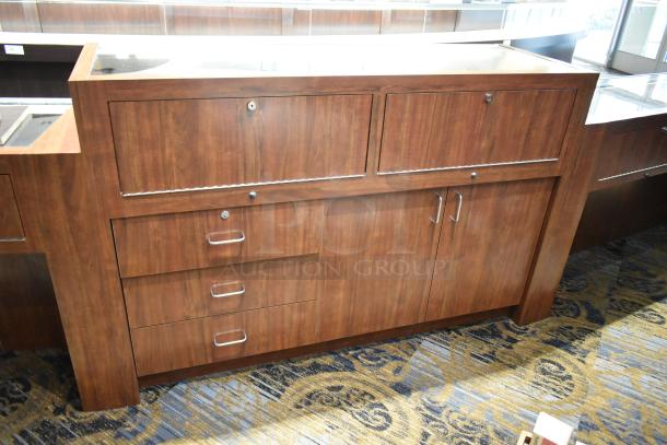 Wooden lighted jewelry case with two rear doors and three drawers. Buyer removal required. Bring tools and help.