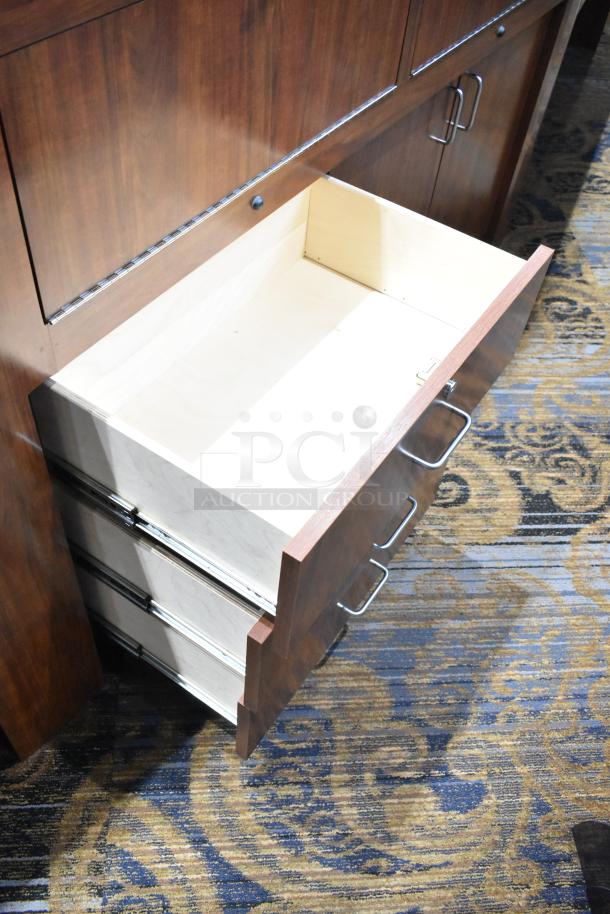 Wooden lighted jewelry case with 2 rear doors, 3 open drawers, metal handles; bring tools for removal.