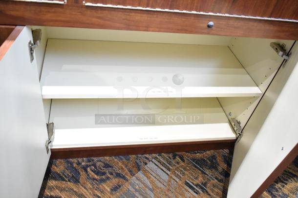 Wooden lighted jewelry case with two rear doors, three drawers, open cabinets, in good condition. Buyer must remove.