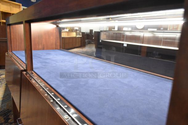 Wooden lighted jewelry case, 2 rear doors, 3 drawers, blue interior, buyer removes, bring tools and manpower.