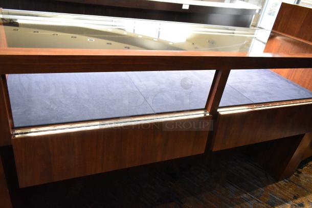 Wooden lighted jewelry case, glass top, good condition, dark wood finish, features built-in lighting. Buyer must remove.