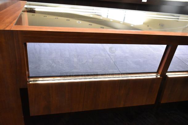 Wooden lighted jewelry case with glass top, in excellent condition. Buyers need to bring tools for removal.