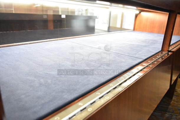 Wooden lighted jewelry case with blue velvet interior. Good condition. Buyer must remove with tools and manpower.