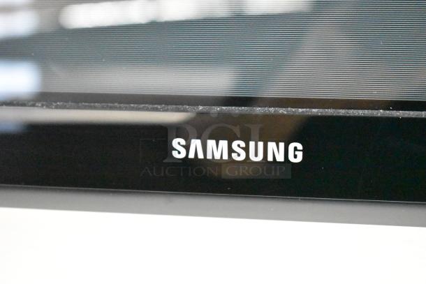 Samsung television screen corner showing brand logo. Buyer must remove; bring tools and manpower.