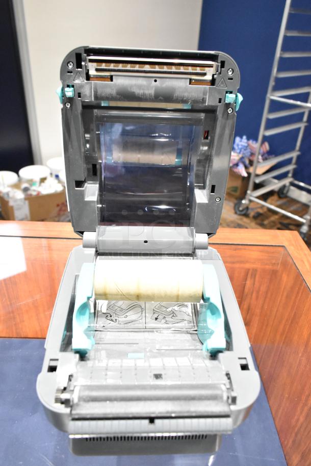 Zebra ZP 450 label thermal printer, open with label roll inside. Visible internal components, used condition.