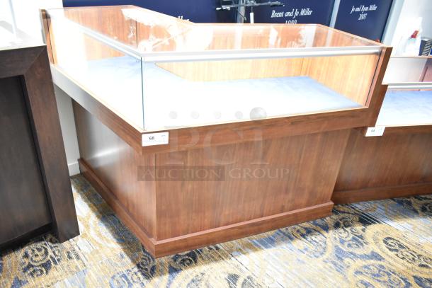 Wooden corner-style lighted jewelry case with glass top, two rear doors, and three drawers. Good condition.