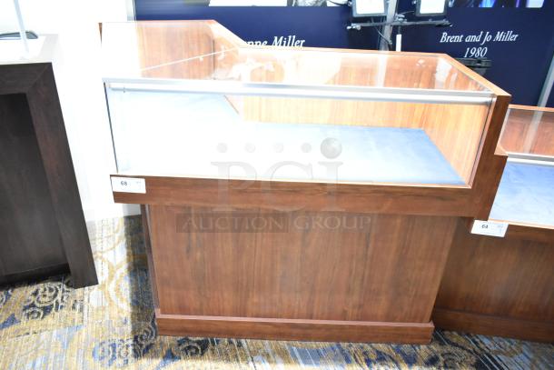 Wooden corner lighted jewelry case with glass top, two rear doors, and three drawers. Requires removal tools. Tags "68" visible.