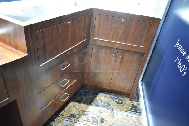 Wooden corner-style lighted jewelry case with two rear doors and three drawers, excellent condition. Tools needed for removal.