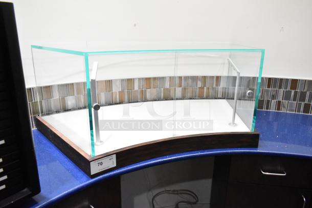 Glass countertop display case with metal supports, wooden base, and matching curved design, excellent condition.