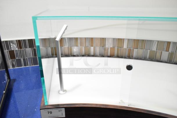 Glass countertop display case with a metal frame, curved glass, and wood base. Good condition, labeled "70" with auction details.