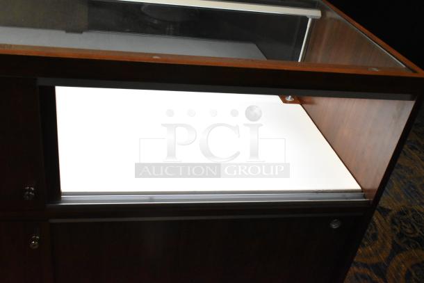 Wooden lighted jewelry display case, glass top, dark wood finish, built-in lighting, lockable, excellent condition.