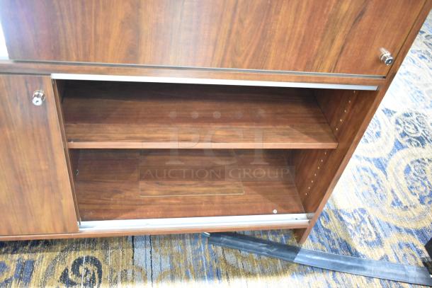 Wooden lighted jewelry case with glass shelves and locks, in fair condition. Buyer must bring tools to remove.