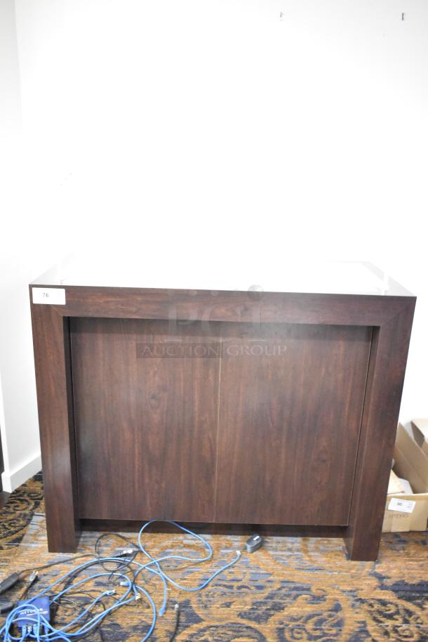 Dark brown wooden counter with a rectangular shape, featuring a smooth finish and a numbered label "76" on the corner.