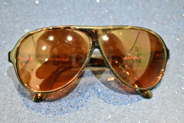 Brand new sunglasses with brown tortoise shell frames, BluBlocker brown lenses; excellent condition.