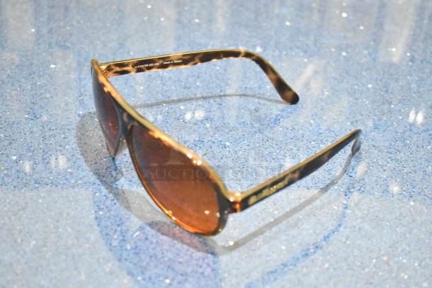 Brand new brown tortoise shell sunglasses with BluBlocker brown lenses, sleek frame, and "Made in Taiwan" marking.