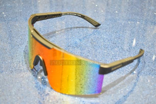 BRAND NEW tan-framed sunglasses with gradient orange lens, stylish and reflective; label indicates made in China.