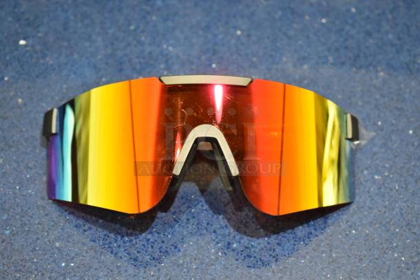 Brand new tan framed sunglasses with reflective orange lens, full wrap style, pristine condition, no visible markings.