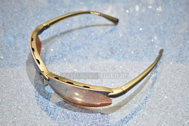 Brand new gray framed sunglasses with BluBlocker brown lenses, sleek design, excellent condition.