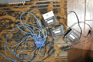 Four items: 3 Binary B-200-1CAT-VGA transmitters with labels and 1 Netgear GS105 ProSafe 5 Port Gigabit Switch with cables.