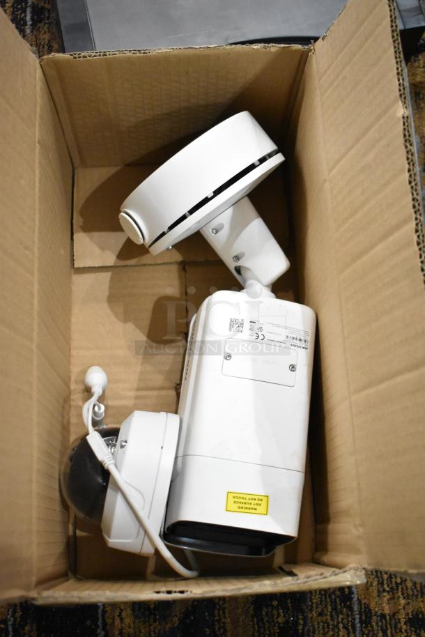 Cardboard box containing Hikvision DS-2CD7A26G0/P-IZHS network camera and NC-KDO32 IR network camera, in used condition.