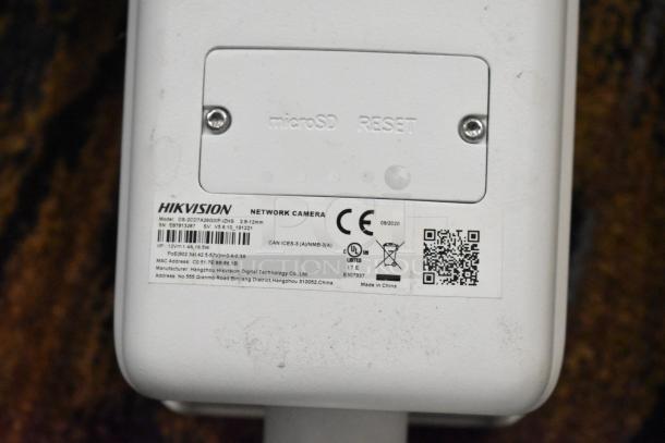 Hikvision DS-2CD7A26G0/P-IZHS network camera showing model label and specifications. Item includes 2 cameras.