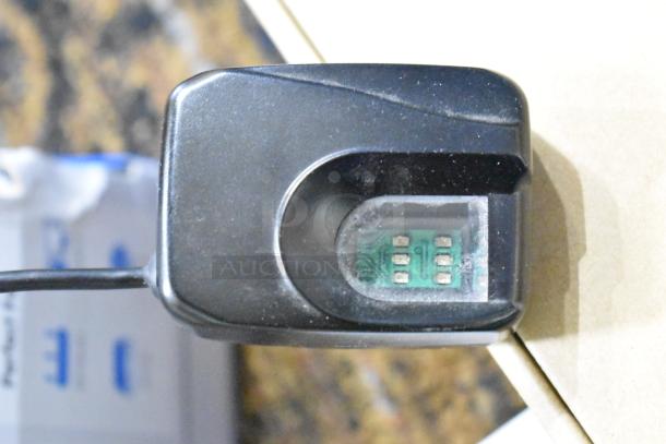 Futronic FS80 fingerprint scanner, black, with visible sensor and cable, in used condition.