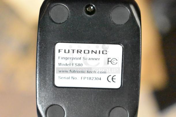 Futronic FS80 Fingerprint Scanner, model FS80, with label showing serial number FP182304 and CE mark.