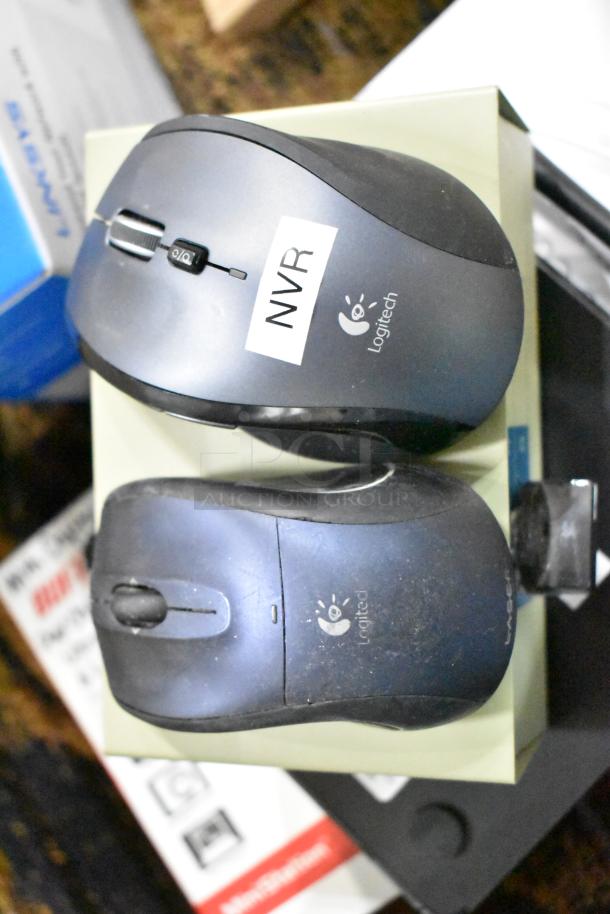 Logitech computer mice, one with "NVR" label, among various tech items including router, switch, and HDMI cable.