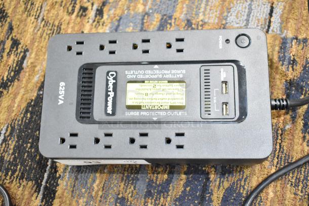 CyberPower ST625U Standby UPS, 625VA, surge protected outlets, USB ports, black, good condition, top view.