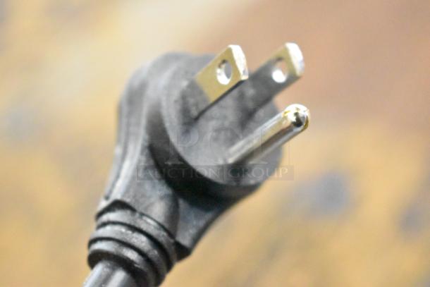 Close-up of a power plug for a CyberPower ST625U Standby UPS, showing three prongs in good condition.