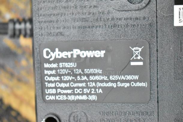 CyberPower ST625U Standby UPS label displaying model, input/output voltage, total output current, and USB power details.