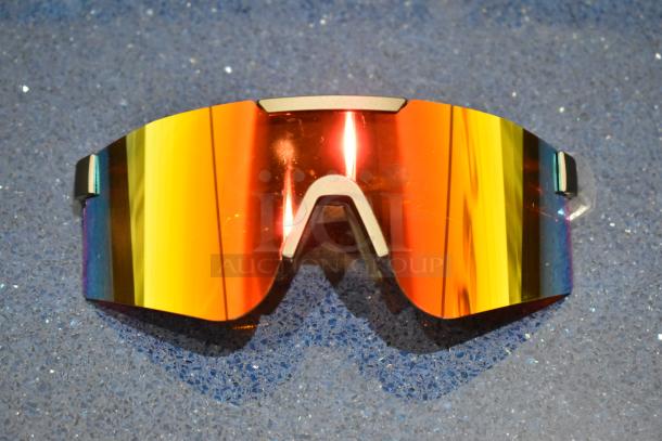 Brand new golden framed sunglasses with vibrant orange lenses, no visible tags or markings, perfect condition.